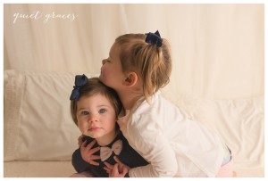 Sisters on a bed photographer studio greenville sc