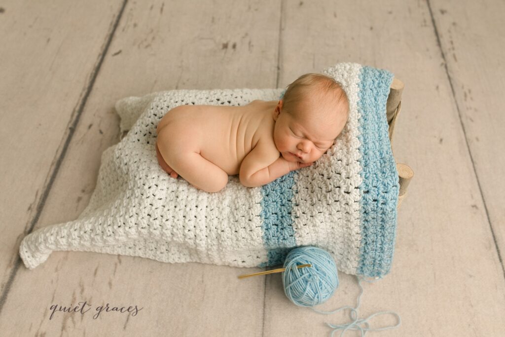 Newborn Baby Travelers Rest sleeping in an unfinished baby blanket made by his great grandmother 
